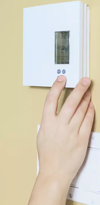 adjusting thermostat temperature in domestic home