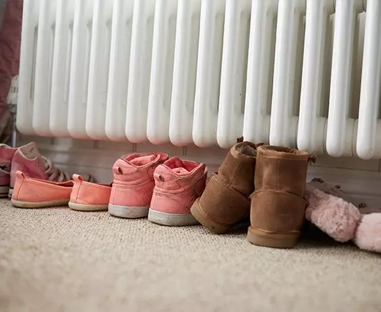 row of shoes under radiator
